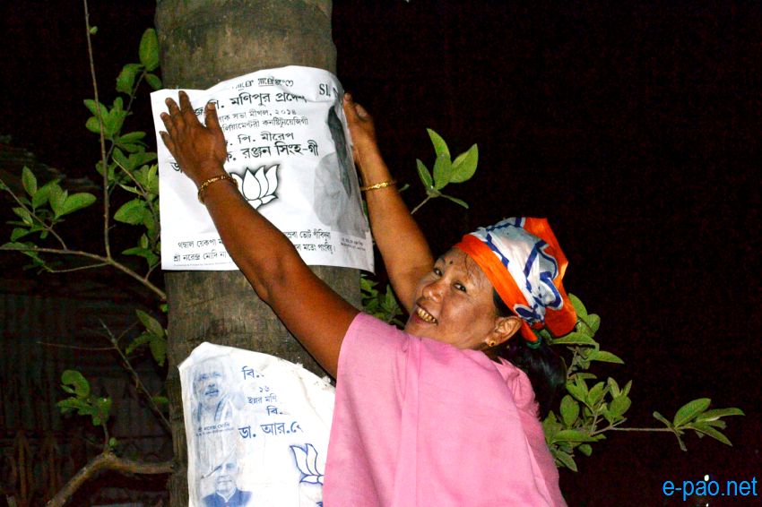 BJP women worker campaigning with posters at night time in Imphal  :: April 2014