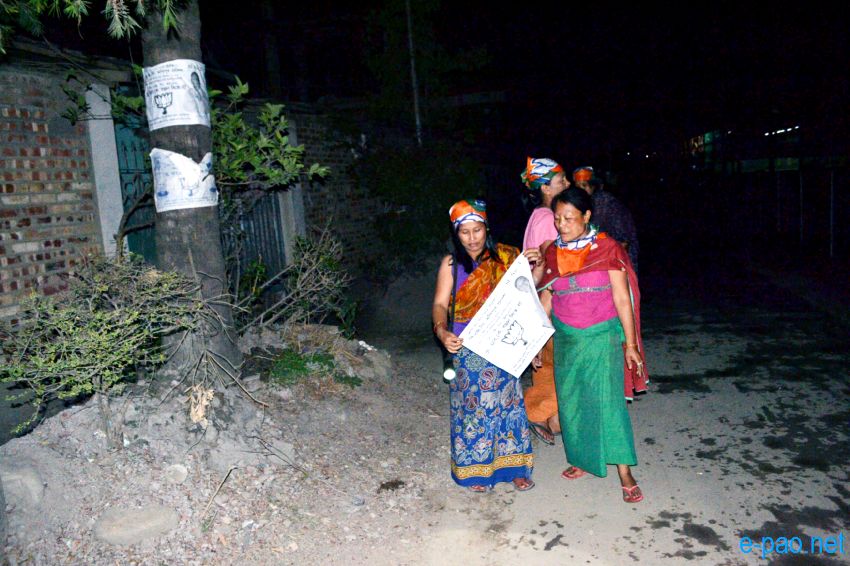 BJP women worker campaigning with posters at night time in Imphal  :: April 2014
