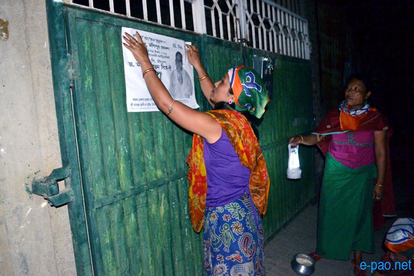 BJP women worker campaigning with posters at night time in Imphal  :: April 2014