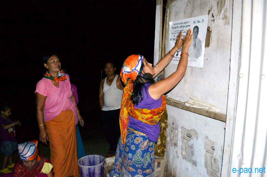 BJP women worker campaigning with posters at night time in Imphal  :: April 2014