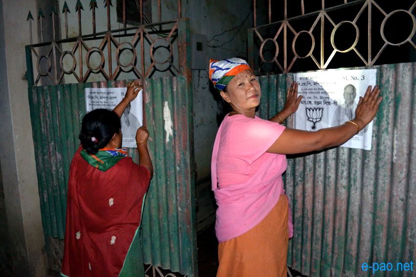 BJP women worker campaigning with posters at night time in Imphal  :: April 2014
