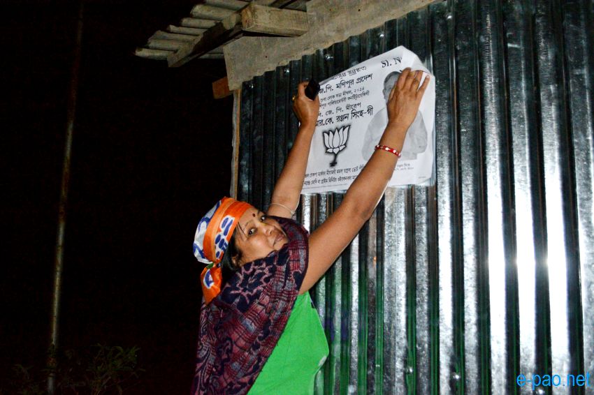 BJP women worker campaigning with posters at night time in Imphal  :: April 2014