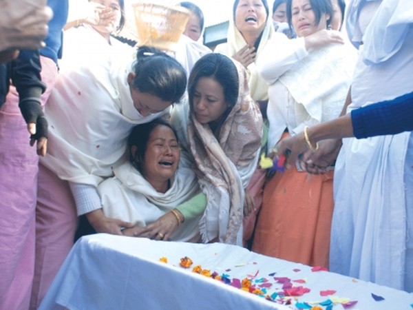 Bereaved family members and relatives trying to console wife of late Dwijamani