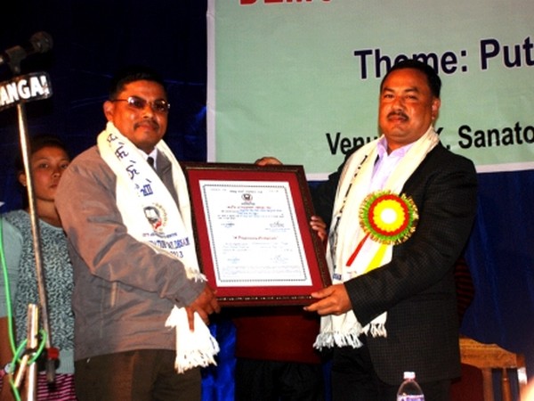 Education Minister Moirangthem Okendro (right) presenting Maichou Khongnangthaba Awards to one of the recipients