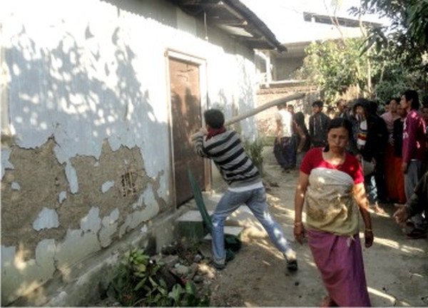 Locals tearing down the house of Haorungbam Surchandra