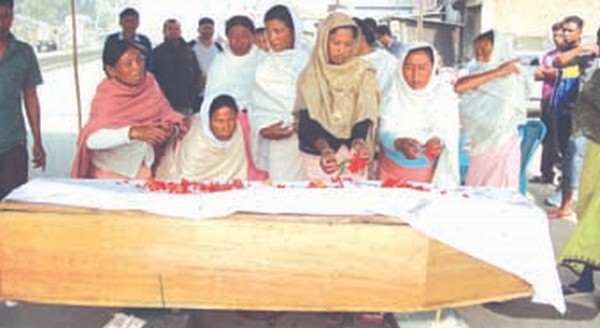 Mourners offering floral tribute to the mortal remains of Ningombam Gobardhon