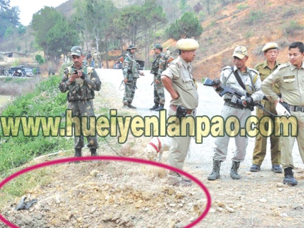 Police and Assam Rifles personnel inspecting the site of the bomb blast at Yairipok