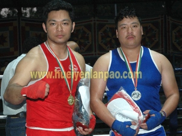 Assam boxer T Ridep Borah (red) and Sikkim boxer Sushil Tamang (blue) after a bought at the 27th NE Games