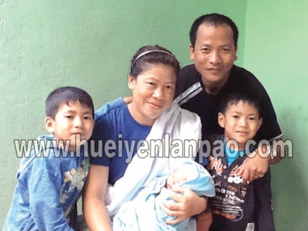 Mary Kom holding her youngest son 'Prince' in her arms