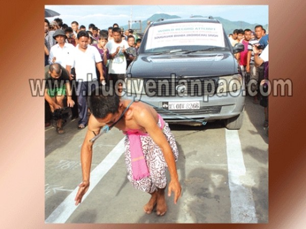 Sougaijam Bhaba pulling the SUV Scorpio with the help of a spear fitted on his throat along the Loklaobung bridge