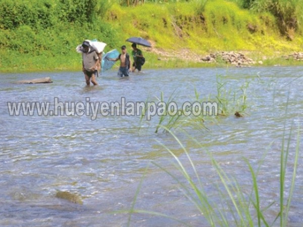 Villagers of Tousem crossing Makru river on their way to work or market