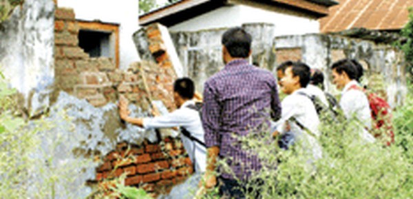 Students dismantling  dilapidated toilets