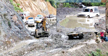 Repairing work of the highway under progress and (inset) a Gypsy half submerged in water