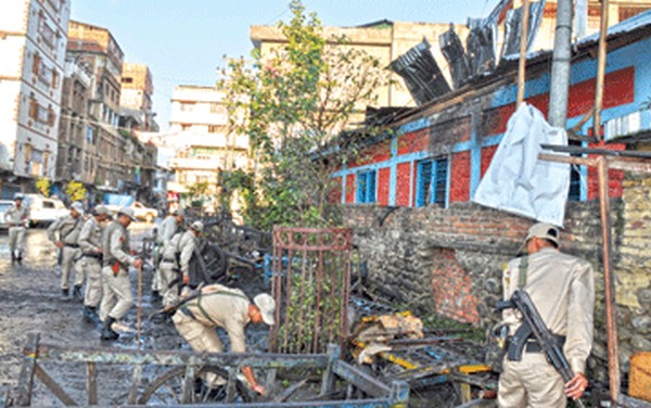 Police at the blast site and the tin roff ripped apart by the powerful blast