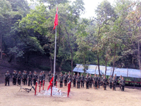 Cadres of PREPAK (Pro) unfurling the party flag during the 36th Rising Day celebration at their tactical headquarters