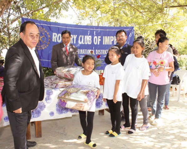 Members of Rotary Club of Imphal extending aids to the inmates of Tabitha Children Home at  Mantripukhri on Sunday