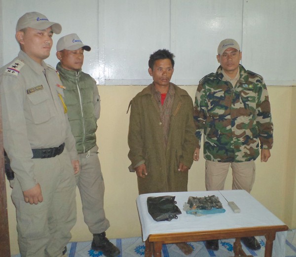 Blast suspect being paraded before media persons along with the seized IED by Thoubal Cdos