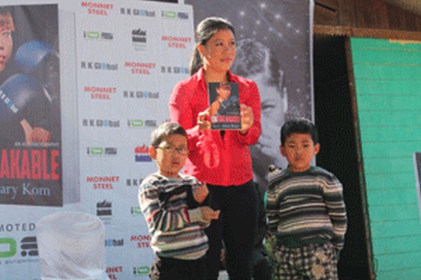 Olympic bronze medallist MC Mary Kom, flanked by twin sons, at the launching ceremony of her autobiography at Imphal College