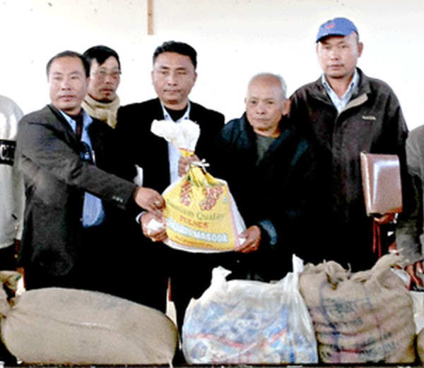 UCM President handing over relief materials to Tuinuphai village chief