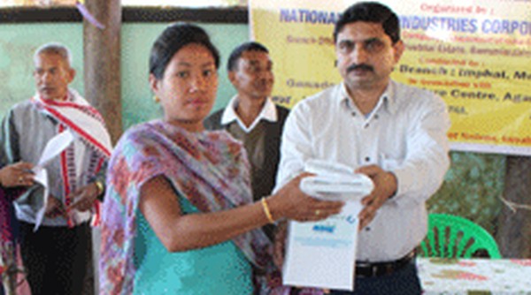 NSIC official distributing the solar lamps