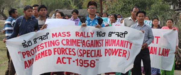 People participate in a rally against AFSPA