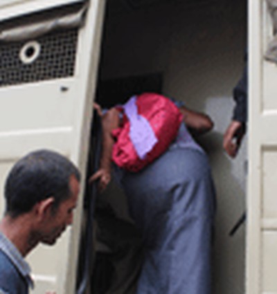 An activist checks a prison van