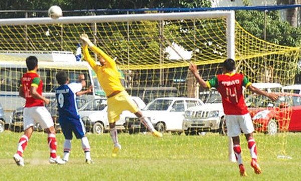 TRAU's goalkeeper punches out a curling shot from the goalmouth