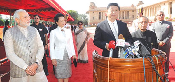 Xi Jinping addresses the media while President Mukherjee and PM Modi look on 