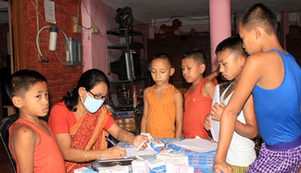 Children being examined by a doctor during the free medical camp in Tera Children Home