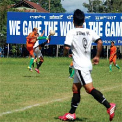 ZFC's player (white) watches his teammate battling for the ball possession against NEROCA's player (orange) during the match