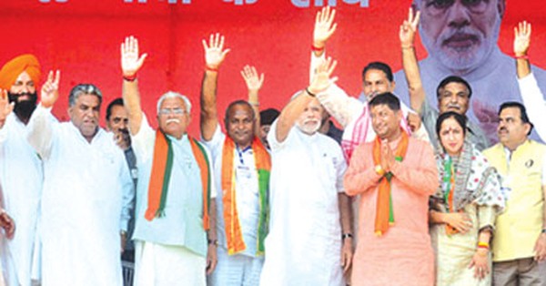 Prime Minister Narendra Modi and others at the podium during an election campaign