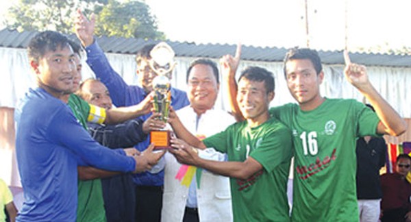 IFCD Minister Ngamthang Haokip handing the 19th Winners' Cup trophy to YPhU players