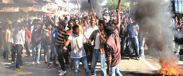 Members of Assam Tea Tribe Students' Association protesting the killings 