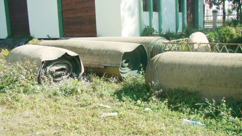 rolls of the old astro-turf lying in a corner on southern side of the hockey stadium, Khuman Lampak