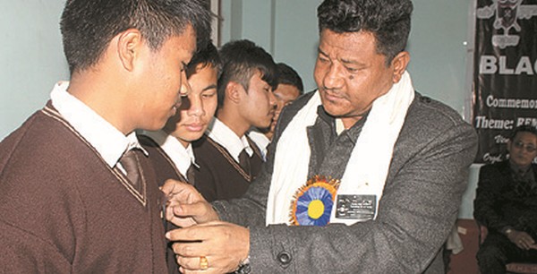Students being adorned with black badges 