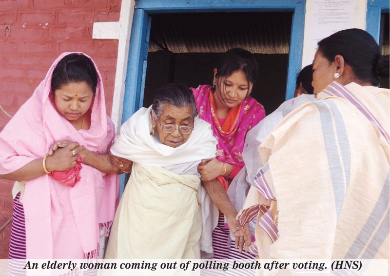 An elderly woman coming out of polling booth after voting