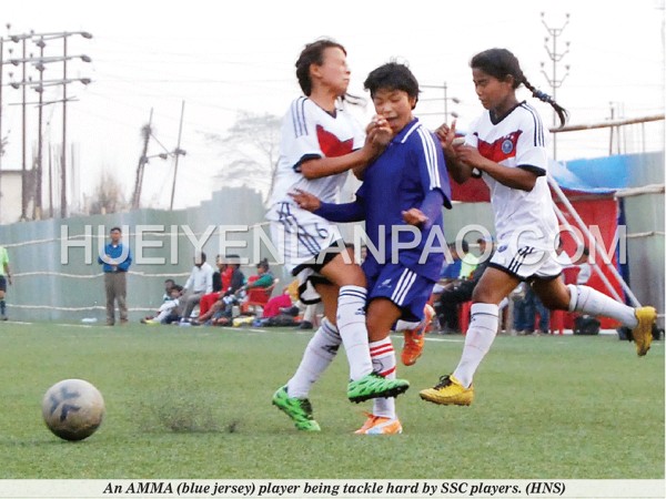 An AMMA (blue jersey) player being tackle hard by SSC players