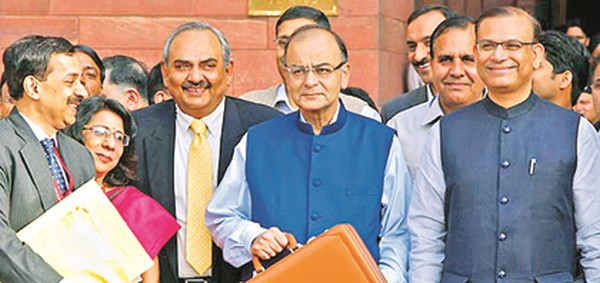 Finance Minister Arun Jaitley leaving office for Parliament 