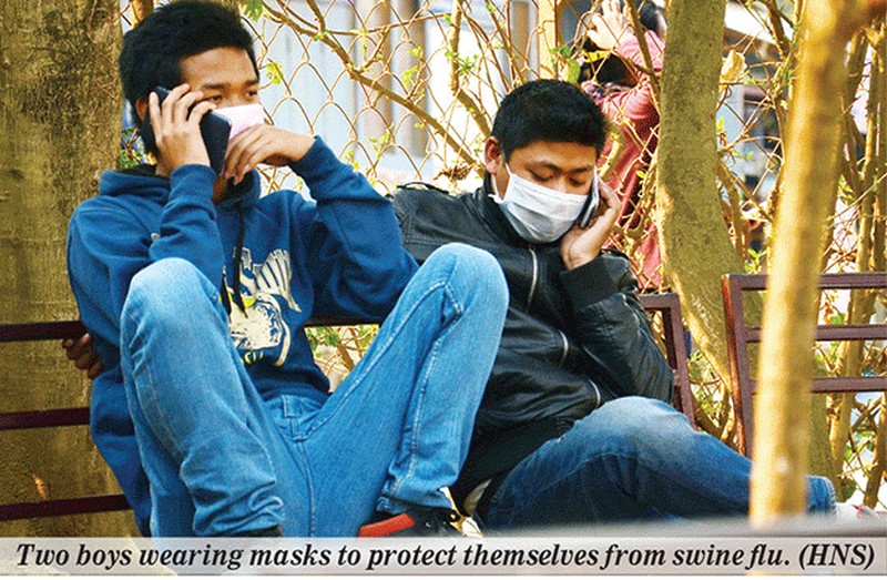 Two boys wearing masks to protect themselves from swine flu