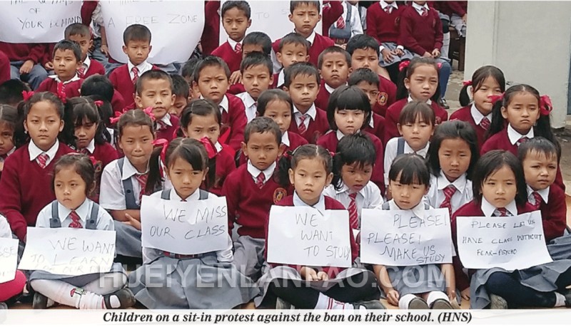 Children on a sit-in protest against the ban on their school