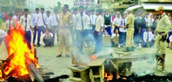 Students setting school furniture on fire on the road 