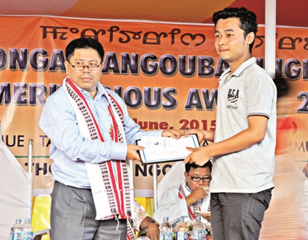 A student being presented with Thongam Angouba Singh Memorial Award
