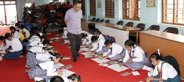 Students participating in the district level painting competition held at Panchayat Bhawan Hall, DC Office Complex, Imphal East