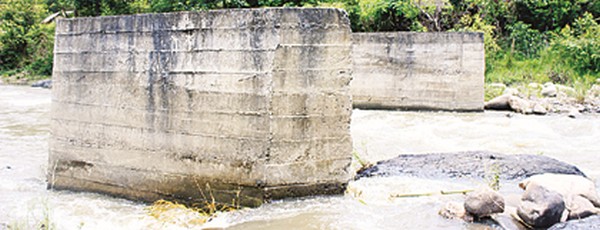 Two unconnected pillars represent a bridge at Wahong village