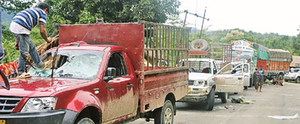 A car being vandalised during public curfew at Jiribam