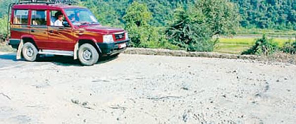 File pic of a vehicle manoeuvring its way through the potholed road on the highway