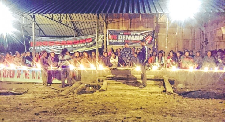 A candlelight vigil underway at Khousabung village market shed