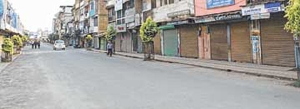 Shops downing shutters in the commercial area of Imphal