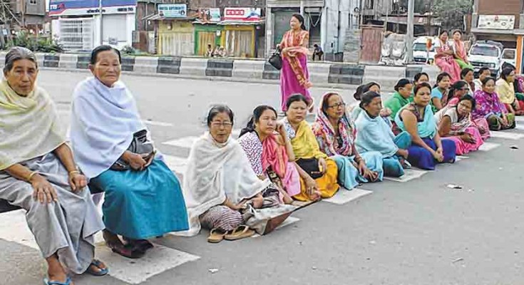 Womenfolk blocking Tiddim road during the public curfew