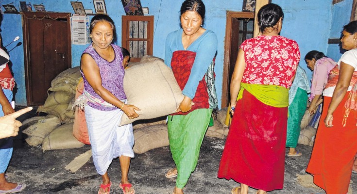 Womenfolk taking out rice bags from FPS agent's home